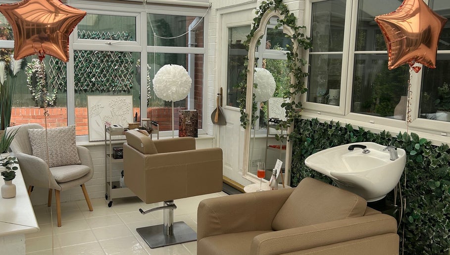 Elegant salon interior at Hair by Chloë Rachael, Pelsall, England, GB featuring stylish chairs and greenery.