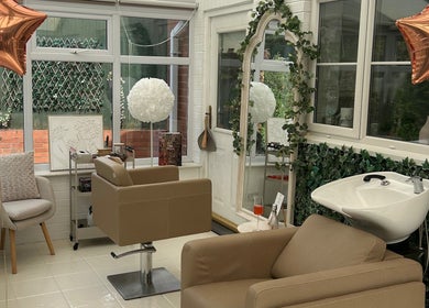 Elegant salon interior at Hair by Chloë Rachael, Pelsall, England, GB featuring stylish chairs and greenery.