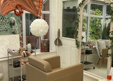 Elegant salon interior at Hair by Chloë Rachael in Pelsall, England, GB with plush seating and decorative mirror.