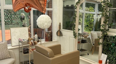 Elegant salon interior at Hair by Chloë Rachael in Pelsall, England, GB with plush seating and decorative mirror.