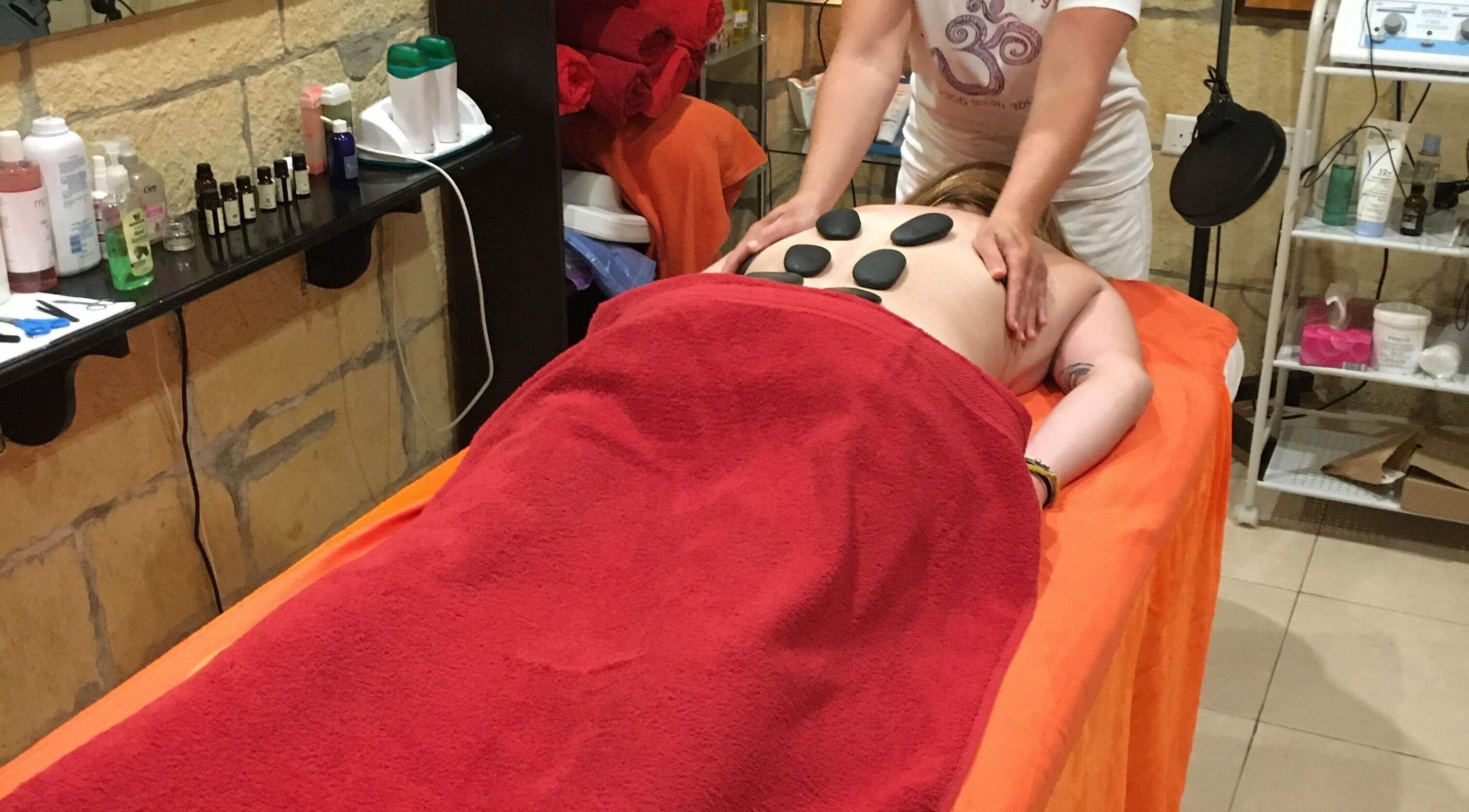 Hot stone massage at Divine Therapy by Katarína in Ix-xagħra, MT offering relaxation and rejuvenation.