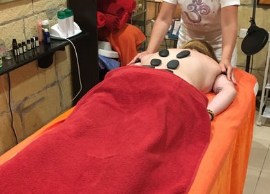 Relaxing hot stone massage at Divine Therapy by Katarína, Ix-xagħra, MT, enhancing wellness.