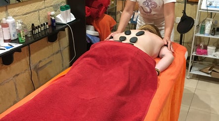 Relaxing hot stone massage at Divine Therapy by Katarína, Ix-xagħra, MT, enhancing wellness.
