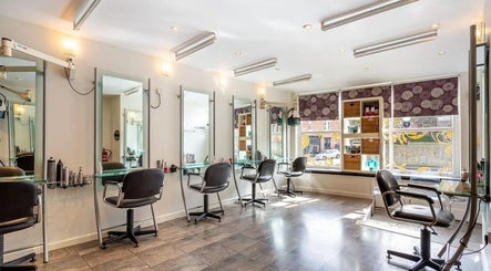 Bright and modern salon interior at Valencia Salon, Newcastle upon Tyne, England, GB with stylish workstations.