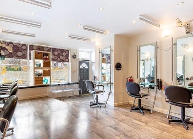 Modern interior of Valencia Salon in Newcastle upon Tyne, England, GB showcasing stylish salon chairs and mirrors.