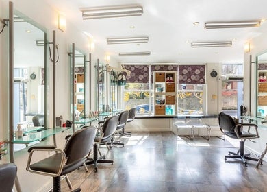 Elegant interior of Valencia Salon in Newcastle upon Tyne, England, GB showcasing sleek salon chairs.