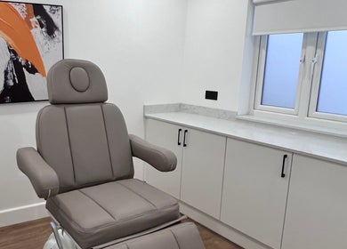 Modern treatment room at Zehra Zem Aesthetics, London, England, GB featuring a comfortable chair and stylish decor.