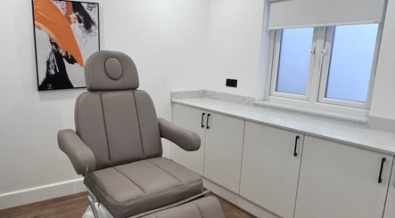 Modern treatment room at Zehra Zem Aesthetics, London, England, GB featuring a comfortable chair and stylish decor.