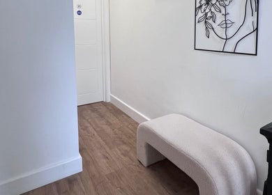 Zehra Zem Aesthetics hallway in London, England, GB showcasing minimalist decor with bench and abstract art.