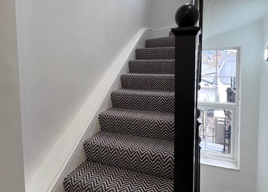 Stylish carpeted stairway at Zehra Zem Aesthetics, London, England, GB, offering a welcoming ambiance.