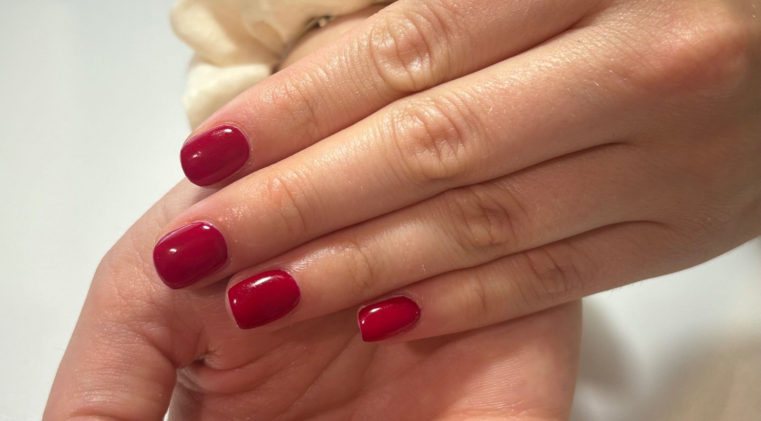 Red manicure at Courtney’sbeautystudio in Keyworth, England, GB showcasing glossy nails with style.