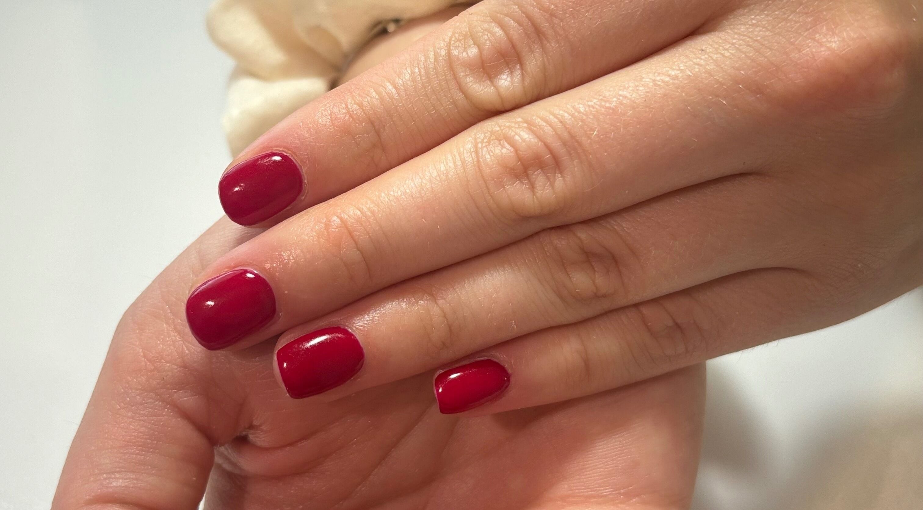 Red manicure at Courtney’sbeautystudio in Keyworth, England, GB showcasing glossy nails with style.