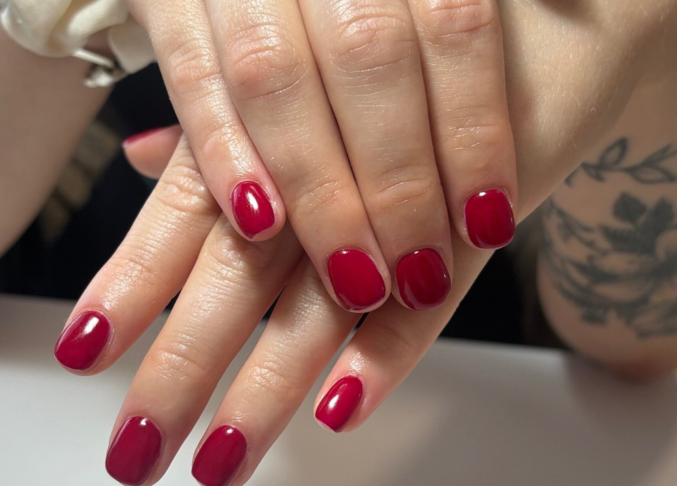 Vibrant red manicure at Courtney’sbeautystudio in Keyworth, England, GB. Perfectly polished nails for a chic look.