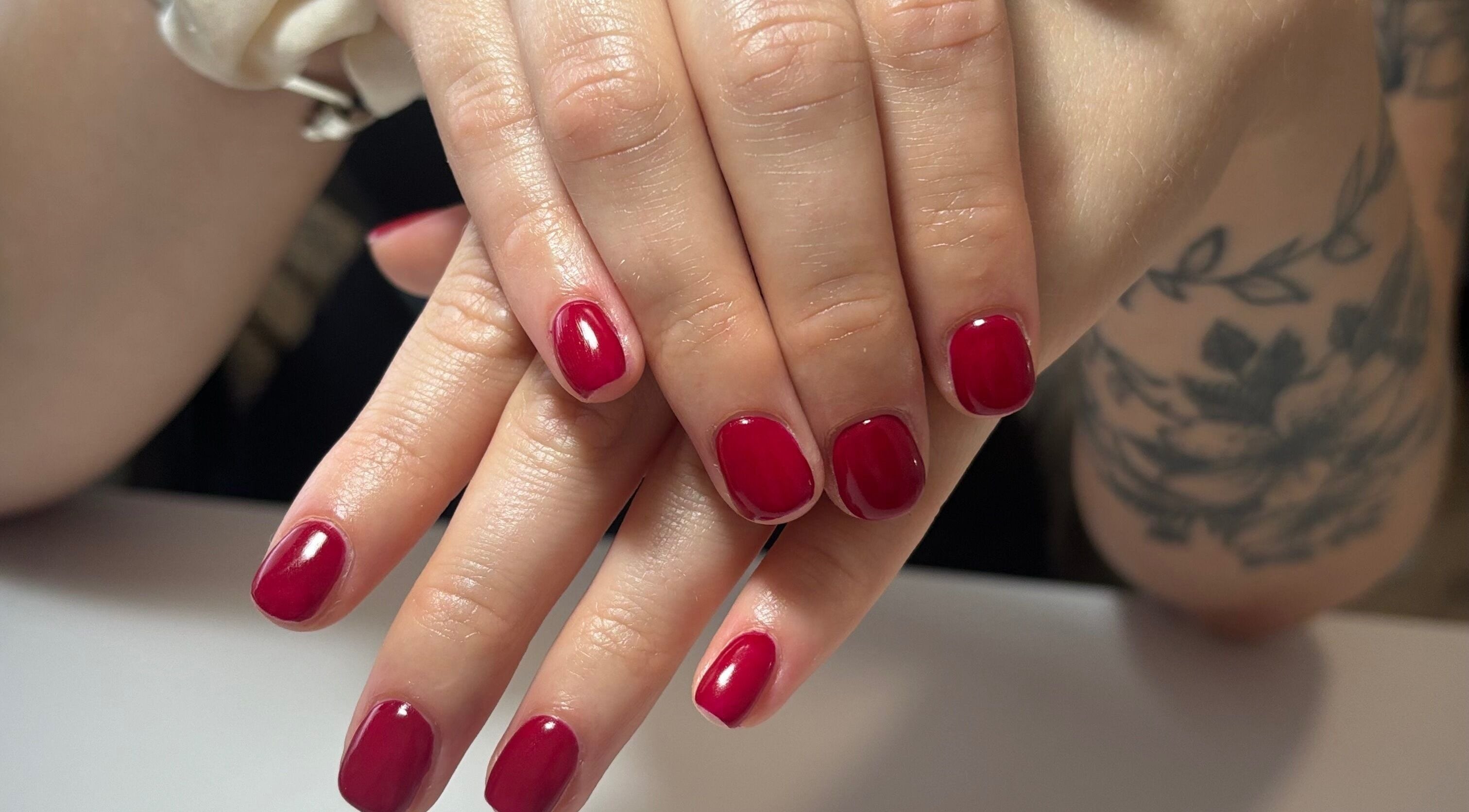 Vibrant red manicure at Courtney’sbeautystudio in Keyworth, England, GB. Perfectly polished nails for a chic look.