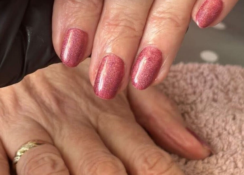 Beautiful pink manicure at Courtney’sbeautystudio, Keyworth, England, GB showcasing detailed nail care.