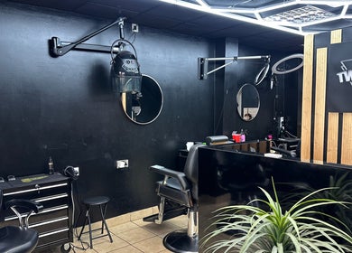 Modern salon interior at Twocees Cuts, Stoke-on-Trent, England, GB showcasing styling stations and mirrors.