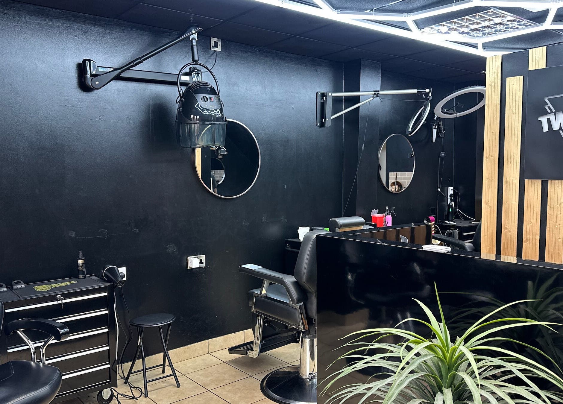 Modern salon interior at Twocees Cuts, Stoke-on-Trent, England, GB showcasing styling stations and mirrors.