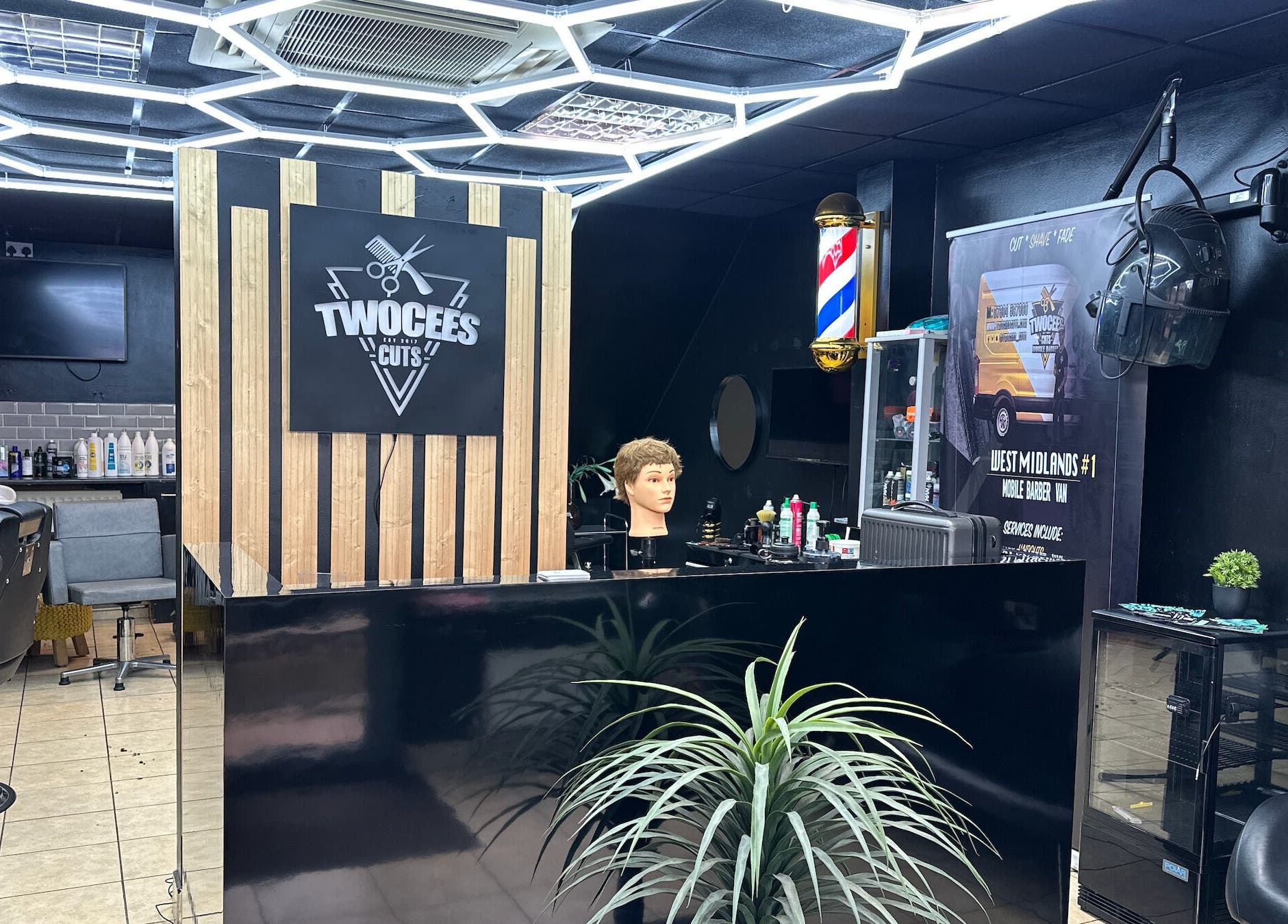 Modern interior of Twocees Cuts, Stoke-on-Trent, England with sleek salon setup and barber equipment.