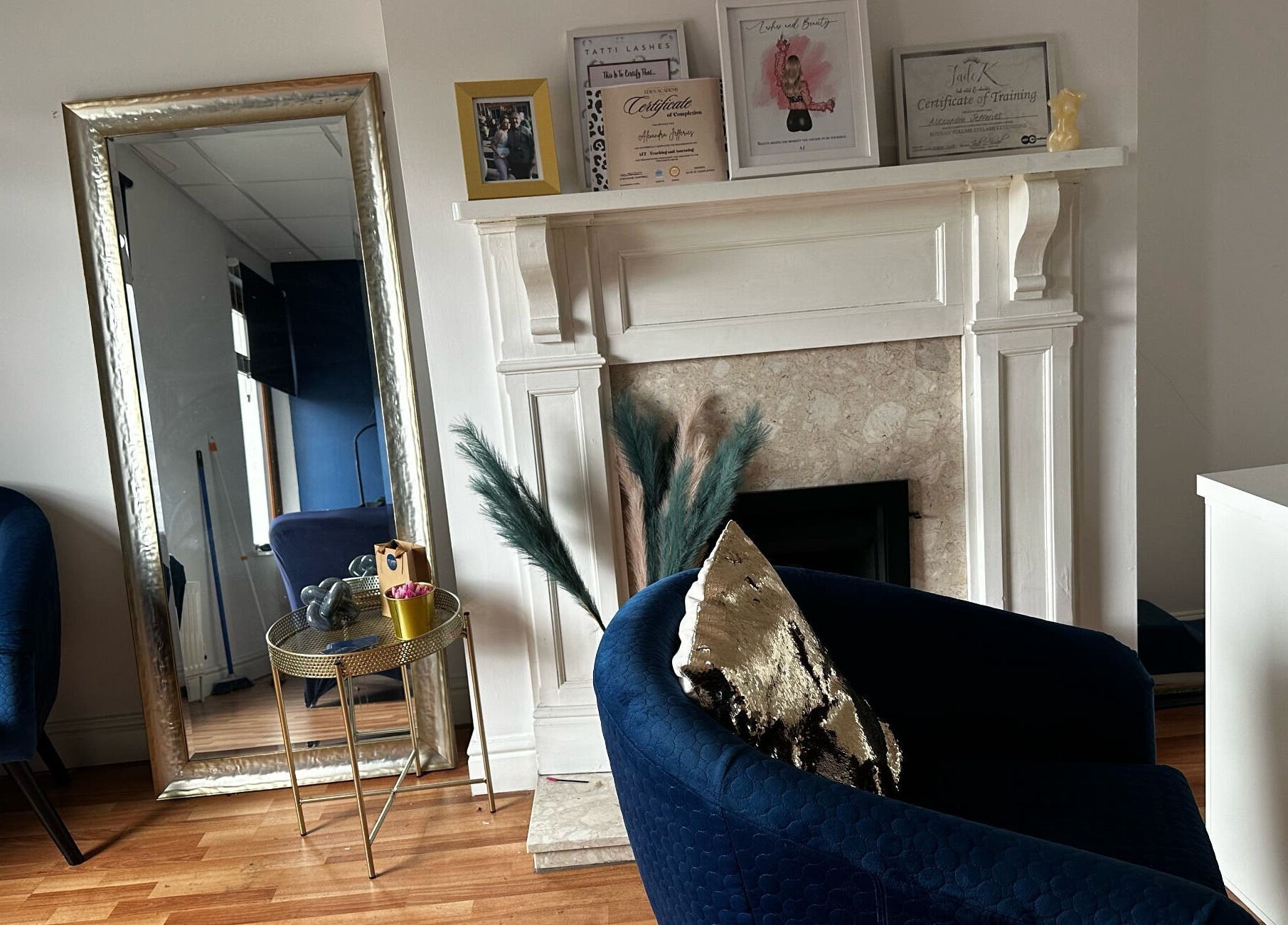 Chic interior at Twocees Cuts in Stoke-on-Trent, England with elegant seating and decor by a fireplace.