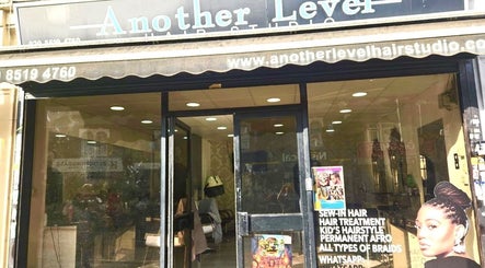 Entrance of Braids By Elilta salon in London, England, GB showcasing modern interior and welcoming signage.