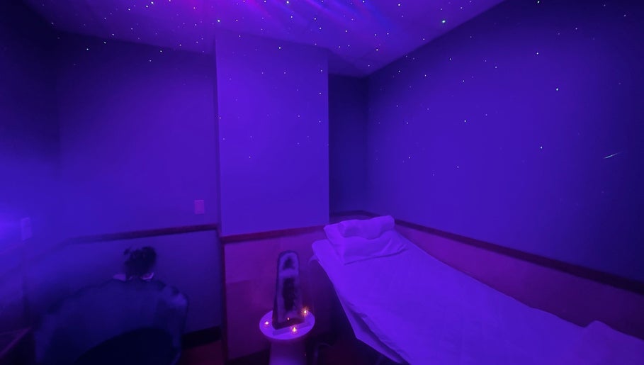 Tranquil purple-lit room at Cynergi Healing Center in Worcester, Massachusetts, US, offering a serene spa experience.