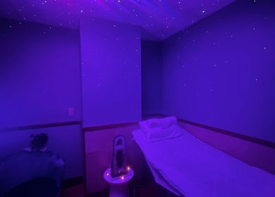Tranquil purple-lit room at Cynergi Healing Center in Worcester, Massachusetts, US, offering a serene spa experience.