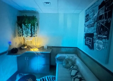 Modern relaxing room at Cynergi Healing Center in Worcester, Massachusetts, US, with blue lighting and decor.