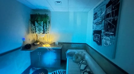 Modern relaxing room at Cynergi Healing Center in Worcester, Massachusetts, US, with blue lighting and decor.