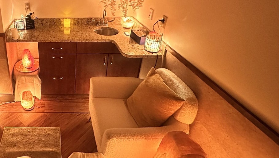Cozy relaxation area at Cynergi Healing Center in Worcester, Massachusetts, US featuring warm lighting and plush seating.