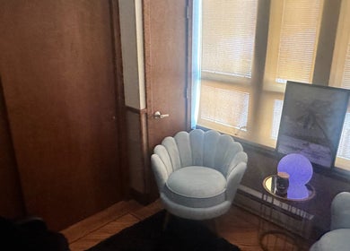 Cozy seating area in Cynergi Healing Center, Worcester, Massachusetts, US with a soft chair and ambient lighting.