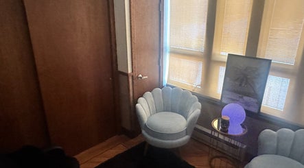 Cozy seating area in Cynergi Healing Center, Worcester, Massachusetts, US with a soft chair and ambient lighting.