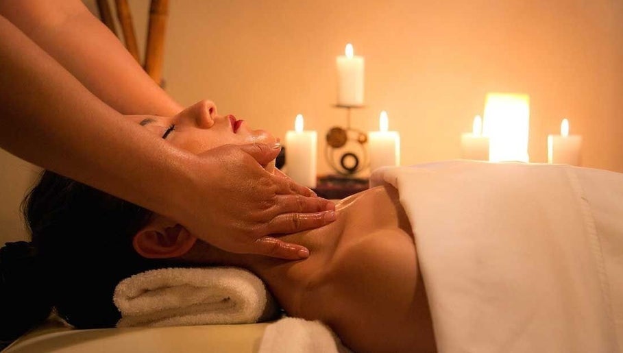 Relaxing massage at Blossom & Be Wellness Studio, Kigali, Kigali City, RW, with candles creating a soothing ambiance.