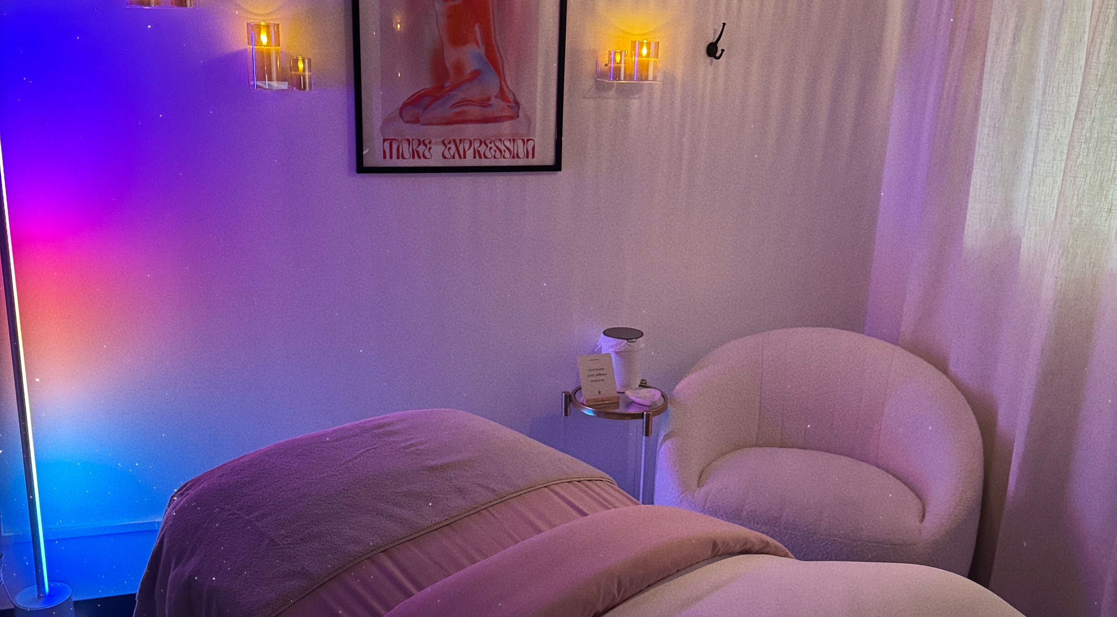 Tranquil massage room at Jenn’s Beauty Lounge, Kyle, Texas, with ambient lighting and plush seating.