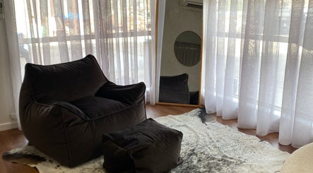 Relaxing corner at The Nail Station, Porepunkah, Victoria, AU featuring plush seating and soft drapes.