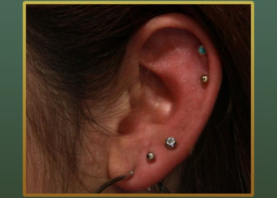 Elegant ear piercings at Gilded Touch Piercings, Glasgow, Scotland, GB showcasing unique jewelry.