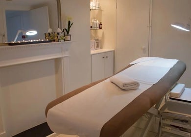Luxe spa room at Lashes by ANNA in Richmond, England, GB, showcasing a tranquil massage table setup.