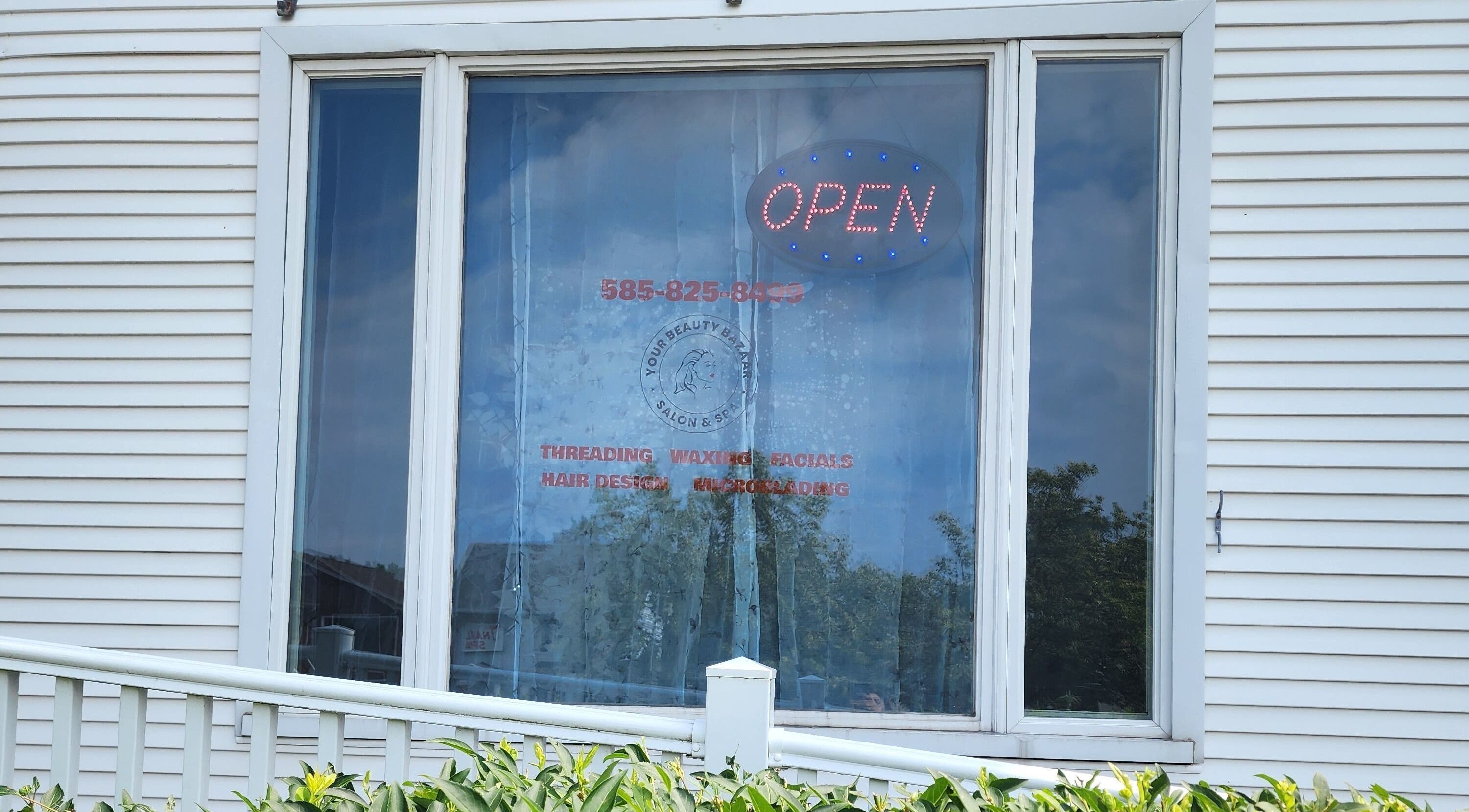 Your Beauty Bazaar Salon & Spa's window with open sign in Rochester, New York, US.