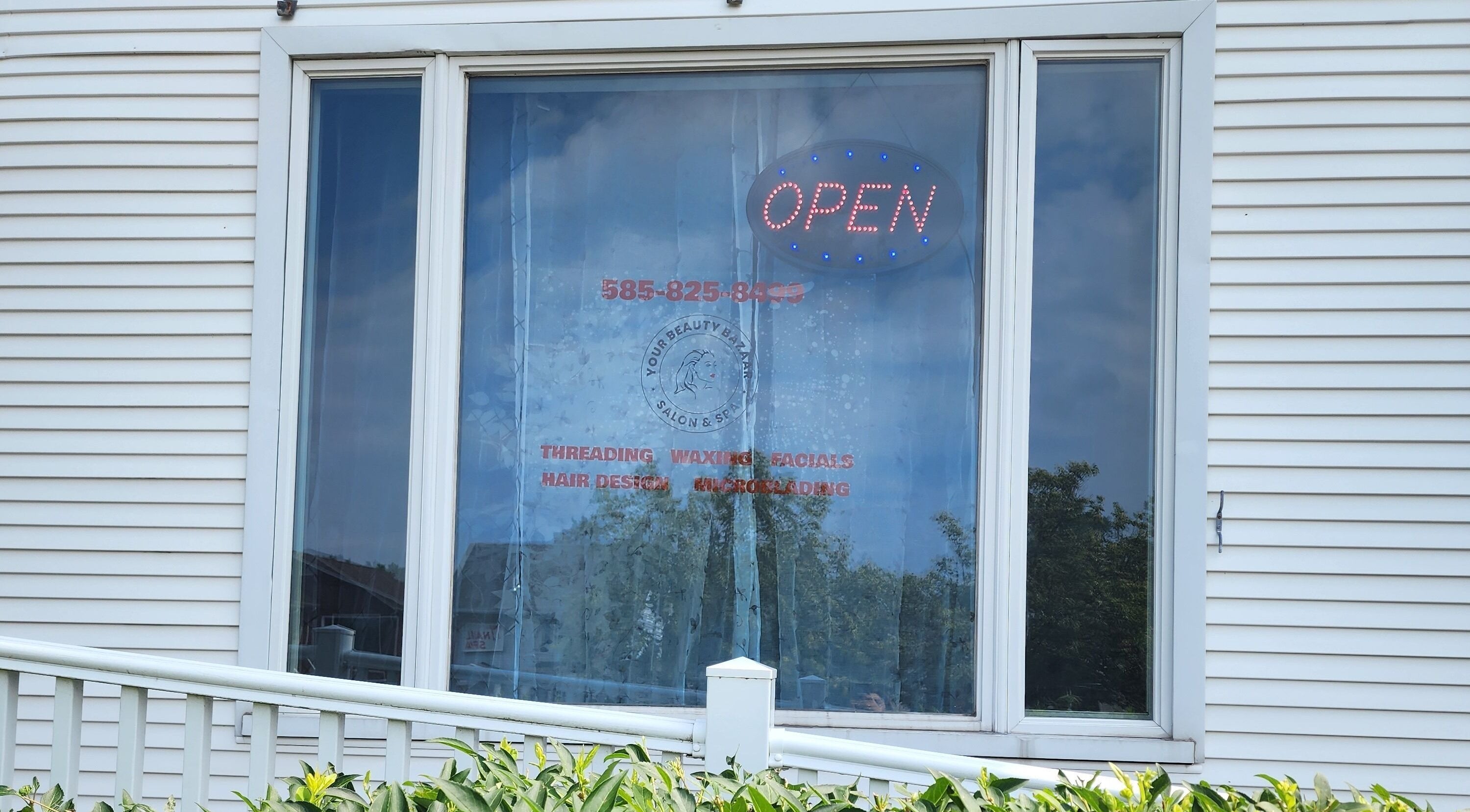Your Beauty Bazaar Salon & Spa's window with open sign in Rochester, New York, US.