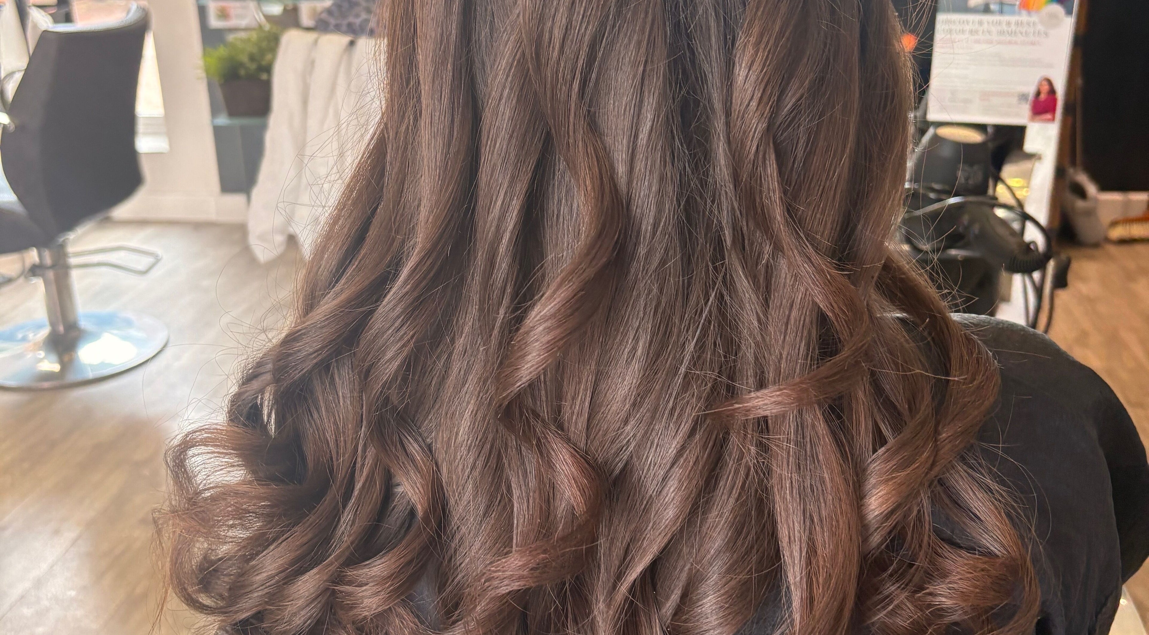 Elegant curled hairstyle at Hair by Gina, England, England, GB salon interior.