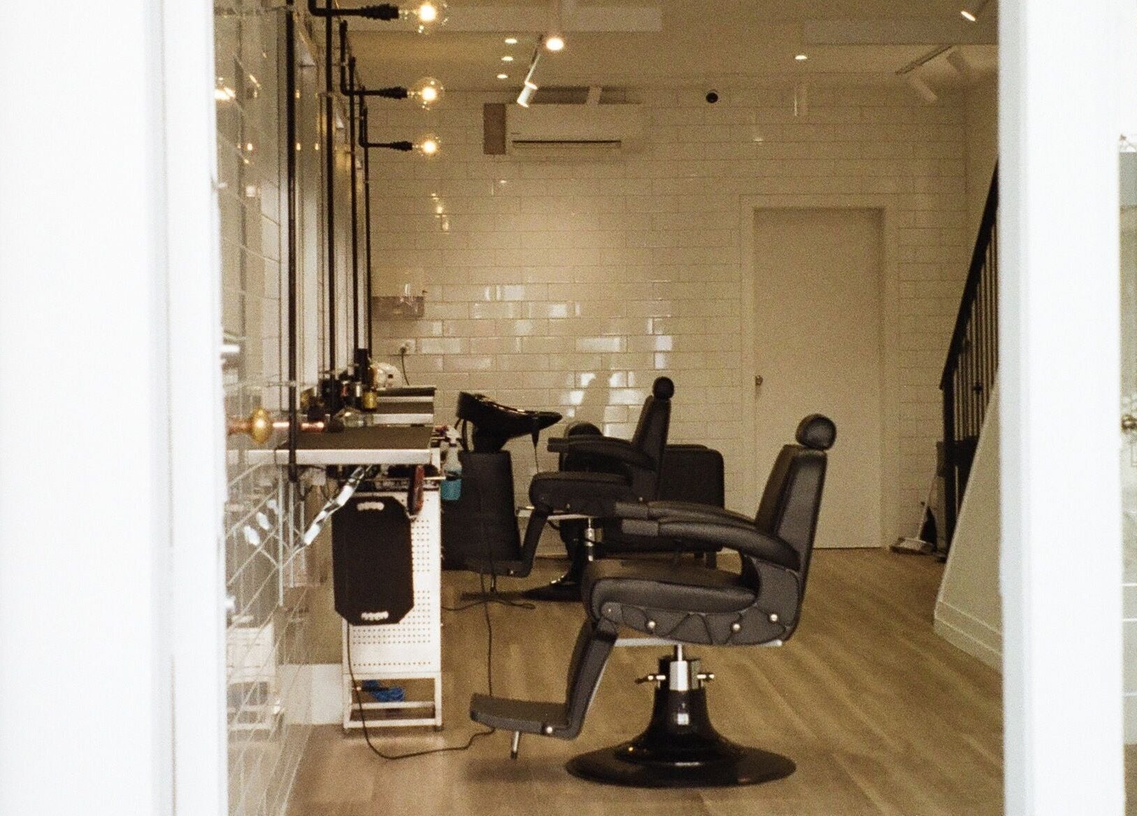 Modern interior of Tokoya Barber and Salon in Auckland, Auckland, NZ, featuring sleek black chairs.