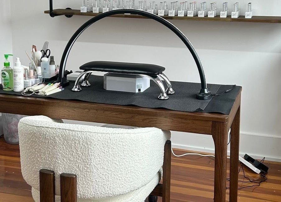 Manicure station at Tokoya Barber and Salon, Auckland, NZ showcasing tools and products on a wooden table.