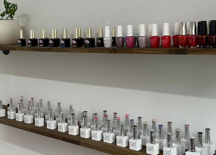 Nail polish shelves at Tokoya Barber and Salon, Auckland, NZ showcasing vibrant gel and traditional lacquers.