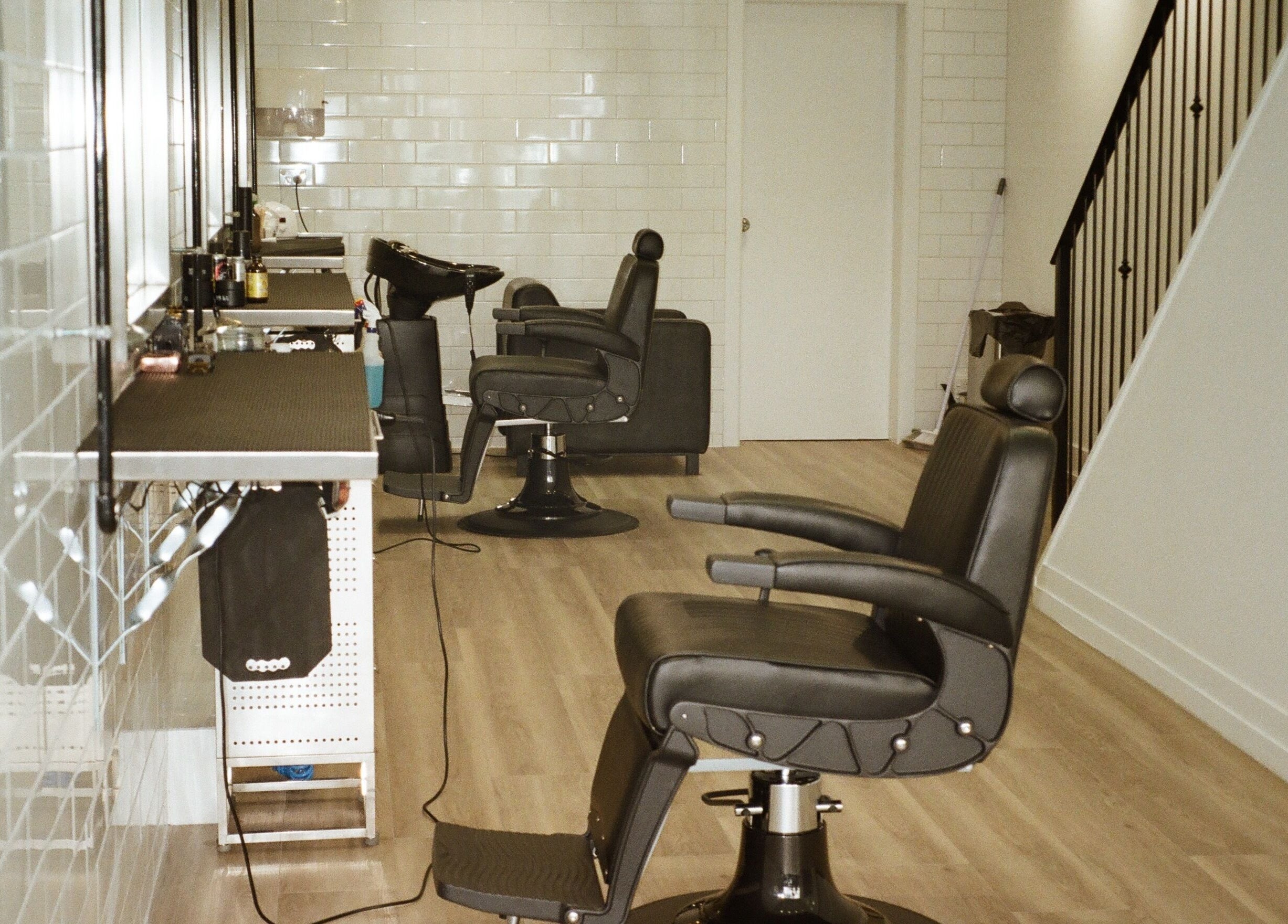 Modern barber chairs in Tokoya Barber and Salon, Auckland, Auckland, NZ with sleek interior design.
