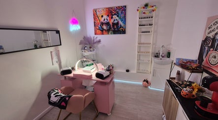 Roxystudio Nails in London, England, GB features a panda art piece and modern nail salon setup.
