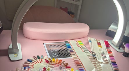 Colorful nail samples under LED light at Roxystudio Nails, London, England, GB, showcasing a vibrant workspace.