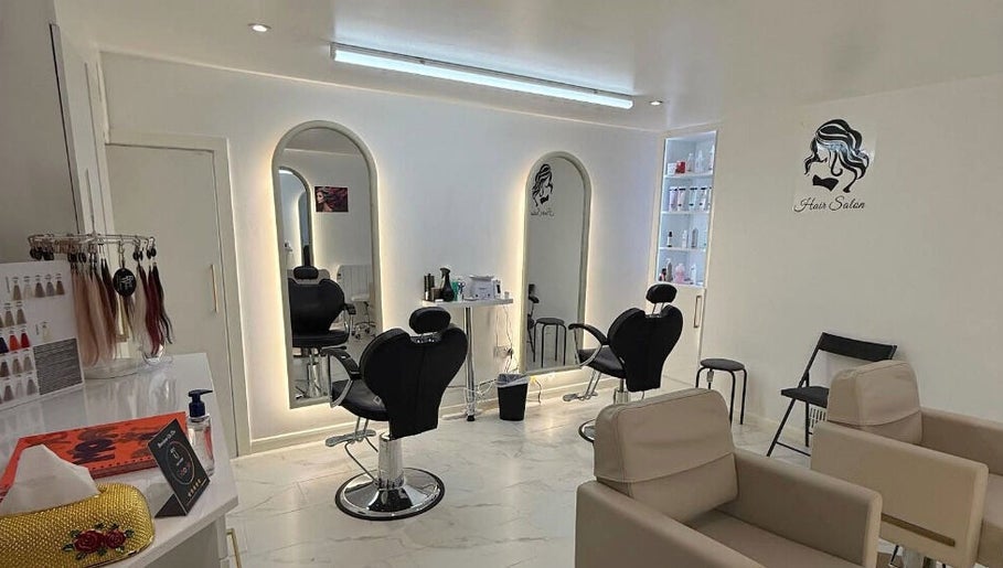 Elegant interior of Glow Beauty Salon in Maidenhead, England, GB with modern styling chairs and mirrors.