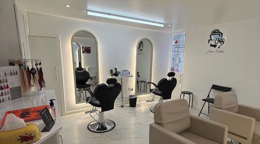 Elegant interior of Glow Beauty Salon in Maidenhead, England, GB with modern styling chairs and mirrors.