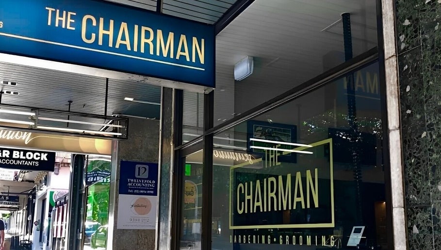 The Chairman barber shopfront in Randwick, New South Wales near Callum Cuts Hair, showcases blue signage.