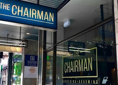The Chairman barber shopfront in Randwick, New South Wales near Callum Cuts Hair, showcases blue signage.