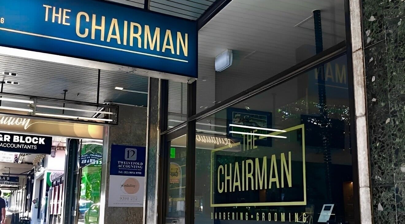 The Chairman barber shopfront in Randwick, New South Wales near Callum Cuts Hair, showcases blue signage.